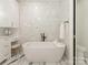 This bathroom features white marble floors, and a tub with marble backsplash at 2326 Lathrop Ln, Charlotte, NC 28211