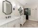 This bathroom includes marble counters, black faucet fixtures, mirrors, and wood look floors at 2326 Lathrop Ln, Charlotte, NC 28211