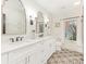 Bright bathroom with double sink vanity with marble countertop and decorative tile flooring at 2326 Lathrop Ln, Charlotte, NC 28211