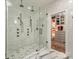 This luxurious marble bathroom offers dual showers and a view of a dressing room at 2326 Lathrop Ln, Charlotte, NC 28211