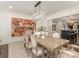 Elegant dining room featuring a rustic wood table beneath a crystal chandelier and an adjacent kitchen at 2326 Lathrop Ln, Charlotte, NC 28211