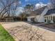 Spacious driveway leads to a three-car garage, complemented by a basketball hoop and soccer net in the backyard at 2326 Lathrop Ln, Charlotte, NC 28211