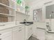 Well-organized laundry room with patterned floor, shelving, and built-in sink at 2326 Lathrop Ln, Charlotte, NC 28211