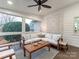 Relax on this screened in porch with overhead fan and decorative white-washed shiplap at 2326 Lathrop Ln, Charlotte, NC 28211