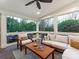 This bright screened porch has comfortable seating, ceiling fan and views of the garden at 2326 Lathrop Ln, Charlotte, NC 28211