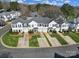 Townhome aerial view with manicured lawns, driveways, and tree-lined street at 2399 Woodridge Dr, Fort Mill, SC 29715