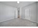 This carpeted bedroom has neutral walls, a closet, and an ensuite bathroom at 2399 Woodridge Dr, Fort Mill, SC 29715