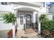 Charming front door with inviting 'Home Sweet Home' doormat and decorative plants at 2399 Woodridge Dr, Fort Mill, SC 29715