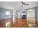 Bright, open living room with hardwood floors, fireplace, and ceiling fan at 2399 Woodridge Dr, Fort Mill, SC 29715