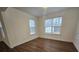 This bedroom has neutral walls, wood-look flooring and two windows to allow for natural light at 2766 Stagbuck Dr, Gastonia, NC 28052