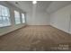 Large bedroom boasts ample natural light from large windows, neutral walls, and soft carpet at 2766 Stagbuck Dr, Gastonia, NC 28052