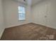 Bedroom featuring neutral walls, plush carpeting, and a bright window at 2766 Stagbuck Dr, Gastonia, NC 28052