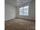 Cozy bedroom features a large window, neutral walls, and plush carpeting at 2766 Stagbuck Dr, Gastonia, NC 28052