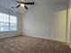 Spacious bedroom features plush carpet, a large window with blinds, and a ceiling fan at 2766 Stagbuck Dr, Gastonia, NC 28052