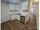 Stylish kitchen boasts granite counters, stainless steel appliances, white cabinets, and wood-look flooring at 2766 Stagbuck Dr, Gastonia, NC 28052