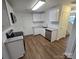 Well-lit kitchen features white cabinets, granite countertops, stainless steel appliances and wood-look flooring at 2766 Stagbuck Dr, Gastonia, NC 28052