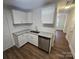 Bright kitchen boasts granite countertops, stainless steel dishwasher, ample cabinet space, and wood-look flooring at 2766 Stagbuck Dr, Gastonia, NC 28052