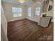 Open-concept space features a living room with wood-look flooring and a view into the eat-in kitchen at 2766 Stagbuck Dr, Gastonia, NC 28052