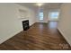 Living room featuring fireplace, neutral walls, and wood-look flooring at 2766 Stagbuck Dr, Gastonia, NC 28052