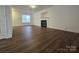 Bright living room features wood-look flooring, a fireplace, and a large window for natural light at 2766 Stagbuck Dr, Gastonia, NC 28052