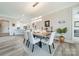 Well-lit dining room features modern chandelier, neutral color palette, and decorative plant at 2823 Providence Rd # 236, Charlotte, NC 28211