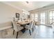 Bright dining area featuring a modern chandelier, a wood table, and seating for six at 2823 Providence Rd # 236, Charlotte, NC 28211