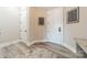 A bright hallway featuring two white doors and luxury vinyl flooring at 2823 Providence Rd # 236, Charlotte, NC 28211