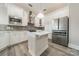 Bright white kitchen with stainless steel appliances, tile backsplash, and a center island at 2823 Providence Rd # 236, Charlotte, NC 28211