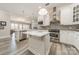 White kitchen features stainless steel appliances, a center island, and hardwood flooring at 2823 Providence Rd # 236, Charlotte, NC 28211