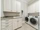 Well-lit laundry room features granite countertops, modern appliances and ample cabinet space for storage at 2823 Providence Rd # 236, Charlotte, NC 28211