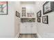 Wet bar featuring white cabinets, a gray backsplash, and stylish decor at 2823 Providence Rd # 236, Charlotte, NC 28211