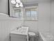 A cozy bathroom featuring a shower, window, and vintage fixtures at 3120 Minnesota Rd, Charlotte, NC 28208