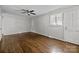 Bright bedroom features hardwood floors, neutral paint, ceiling fan and natural light at 3120 Minnesota Rd, Charlotte, NC 28208