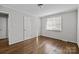 Bedroom featuring hardwood flooring, neutral walls, and bright window at 3120 Minnesota Rd, Charlotte, NC 28208