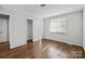 Bedroom features hardwood flooring, closet, and a bright window at 3120 Minnesota Rd, Charlotte, NC 28208