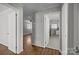 Hallway with hardwood flooring connecting various rooms at 3120 Minnesota Rd, Charlotte, NC 28208