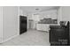 Kitchen featuring stainless steel appliances, white cabinets, and tile flooring at 3120 Minnesota Rd, Charlotte, NC 28208