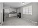 Well-lit kitchen with white cabinets, stainless steel appliances, and tile flooring at 3120 Minnesota Rd, Charlotte, NC 28208