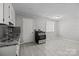 Kitchen area features granite counters, stainless steel range, and tile floors at 3120 Minnesota Rd, Charlotte, NC 28208