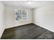 Empty bedroom featuring hardwood floors and a large window with backyard view at 3212 Irwin Valley Ct, Charlotte, NC 28269