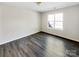 This bedroom features updated flooring and a large window for natural light at 3212 Irwin Valley Ct, Charlotte, NC 28269