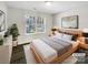 Staged bedroom with a queen size bed, hardwood floors, and large window at 3212 Irwin Valley Ct, Charlotte, NC 28269