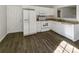 Well-lit kitchen featuring white cabinets and appliances, neutral countertops, and hardwood floor at 3212 Irwin Valley Ct, Charlotte, NC 28269