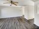 Bright, empty living room featuring hardwood floors, base molding, and large window at 3212 Irwin Valley Ct, Charlotte, NC 28269