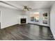 Bright living room with hardwood floors, fireplace, ceiling fan, and backyard view at 3212 Irwin Valley Ct, Charlotte, NC 28269