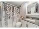 Clean bathroom featuring a shower with leaf-patterned curtain and a light-gray vanity at 3414 Clearview Dr, Monroe, NC 28110