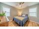 Cozy bedroom featuring hardwood floors, a ceiling fan, and two windows for natural light at 3414 Clearview Dr, Monroe, NC 28110