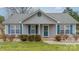 Inviting home featuring blue shutters, a covered porch, and well-manicured landscaping at 3414 Clearview Dr, Monroe, NC 28110