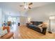 Open-concept living room with hardwood floors, ceiling fan, and a seamless flow to the dining area at 3414 Clearview Dr, Monroe, NC 28110