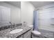 Bathroom showcasing a granite-topped vanity, toilet and a shower tub with a blue patterned curtain at 358 Caffee Dr, Kings Mountain, NC 28086